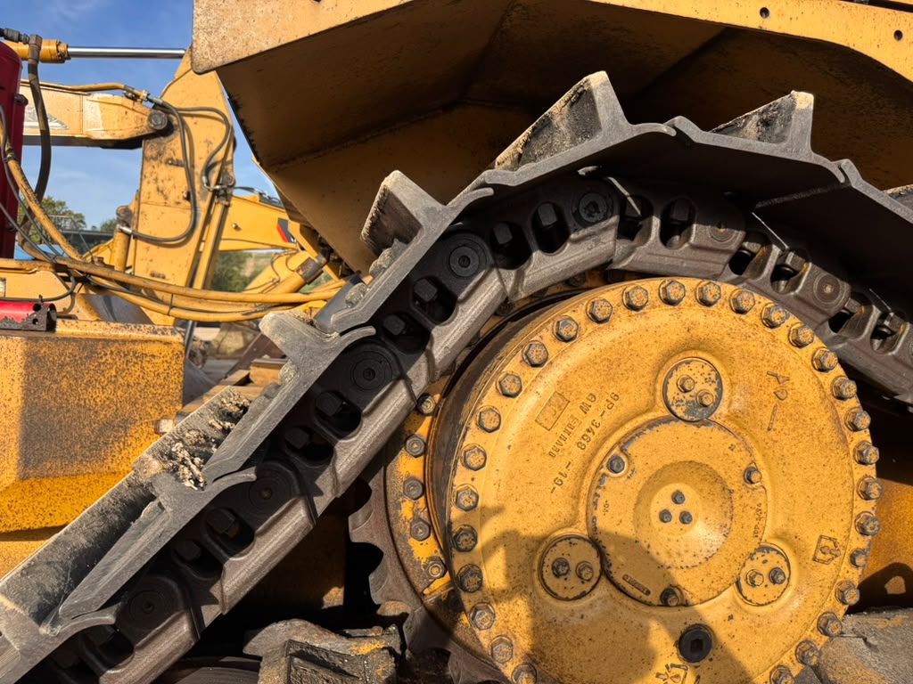 Caterpillar D9T dozer final drive hub and elevated sprocket teeth close up
