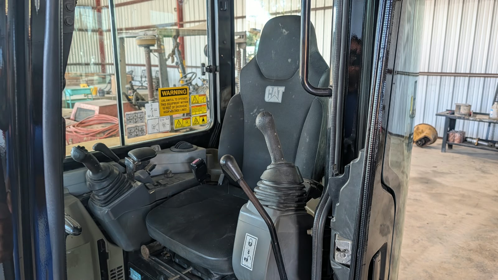 Caterpillar 304E CR Mini Excavator Enclosed Cab Interior Overview with Dual Joystick Controls